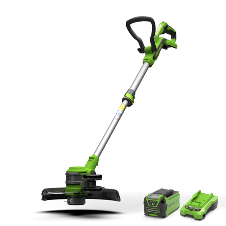 Green and black string trimmer with battery and charger on a white background