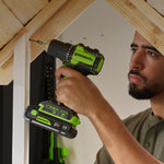 Person using a Greenworks power drill on a wooden structure