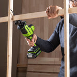 Person using a cordless drill to assemble wooden frames.