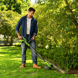 Man using a cordless grass trimmer in a garden